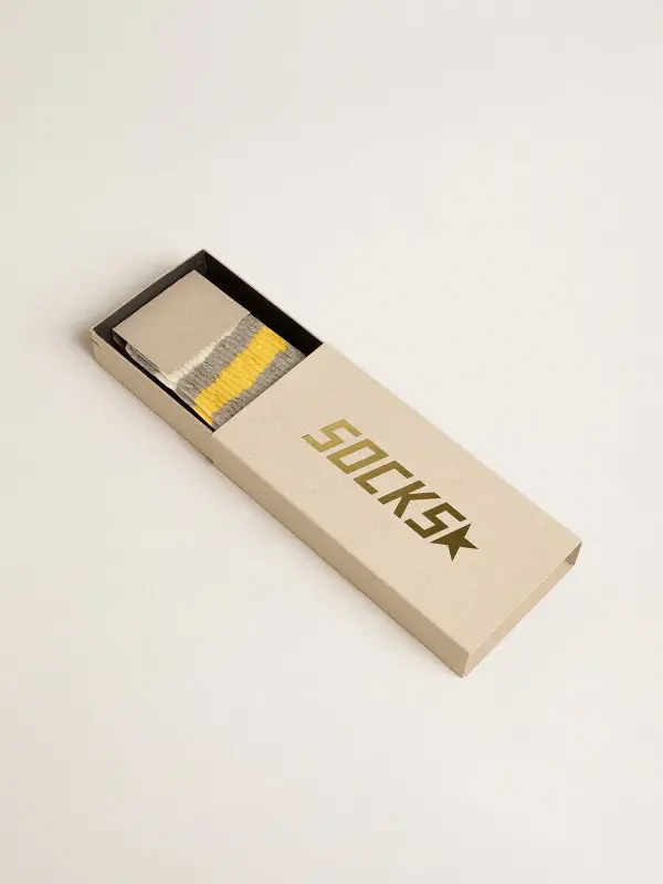 Gray socks with distressed details and yellow and white stripes online
